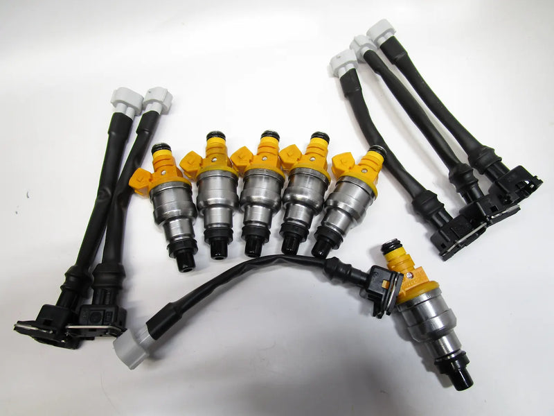 Toyota 3VZE fuel injector upgrade with harness adapter installed